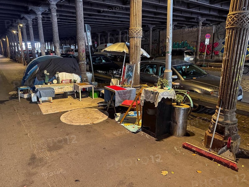 Homeless person's tent in Berlin's Gleim Tunnel. Decorated like an apartment, there is a table with chairs and flowers on a crocodile runner, pictures, cupboards and a broom and dustpan to sweep out. Berlin, 25.10.2025