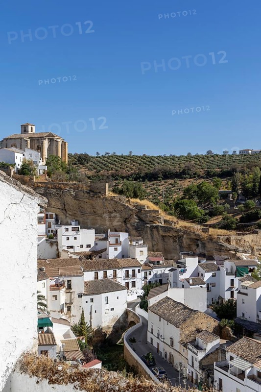 On the road to the white villages. Panorama or skyline of a historic old town with many white houses built on and in the mountain. Setenil de las Bodegas, Andalusia, Spain