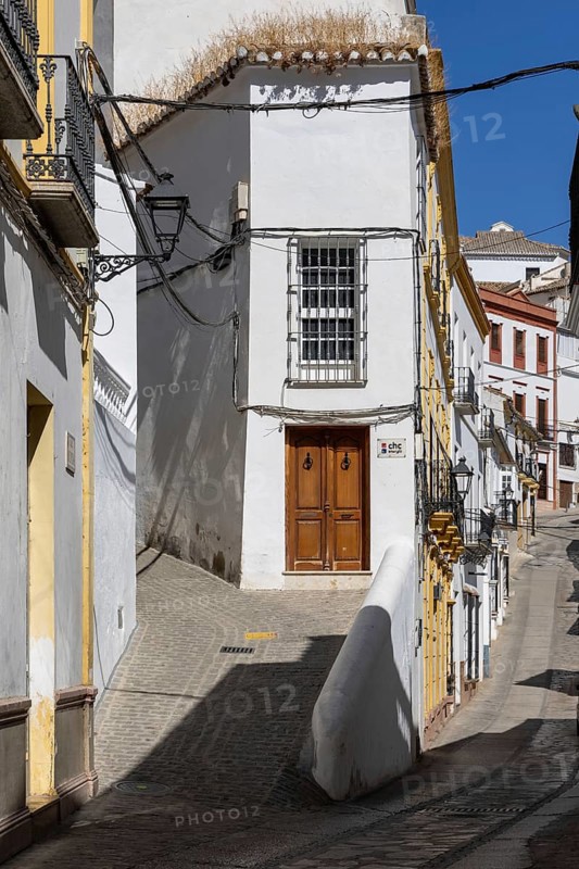 On the road to the white villages. Paths and narrow streets of a historic old town with many white houses built on and in the mountain. Setenil de las Bodegas, Cadiz, Andalusia, Spain