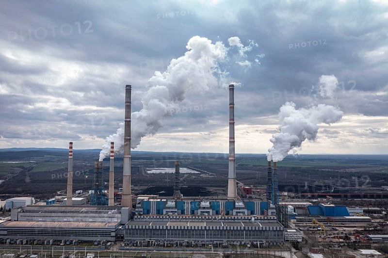 Aerial view of a large power plant with smokestacks emitting smoke into a cloudy sky. Aerial view of thermal power plant Maritsa East 2 Stara Zagora Region, Bulgaria