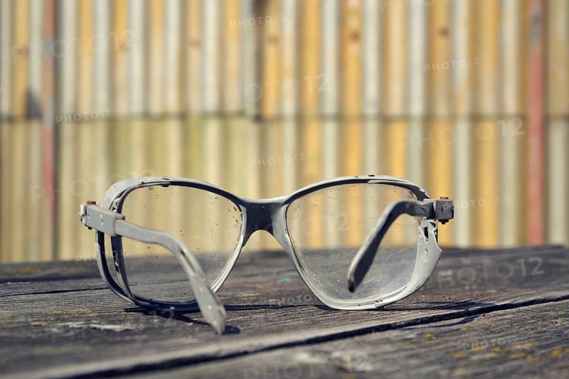 Filtered picture of a vintage safety glasses on a wooden table Prague Czech republic