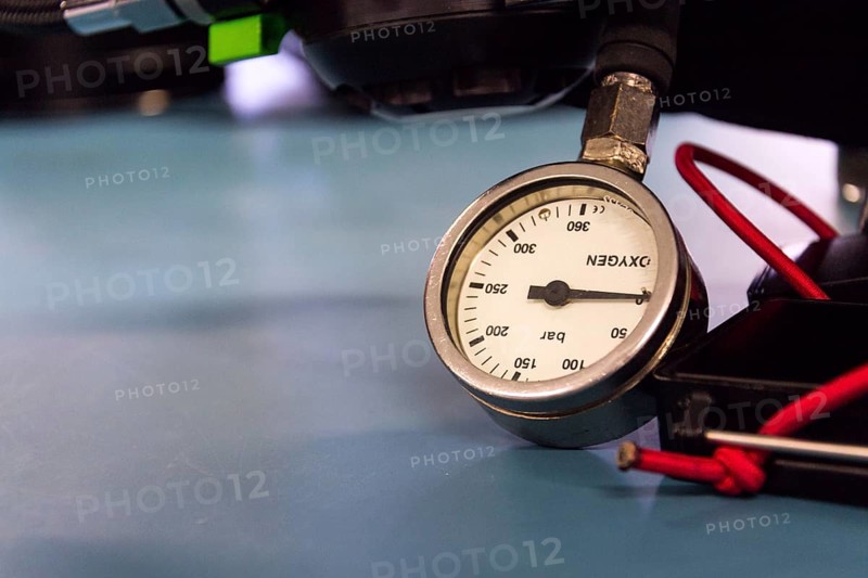 Gas pressure indicator, scuba diving oxygen lying on blue table background, copy space Prague Czech republic