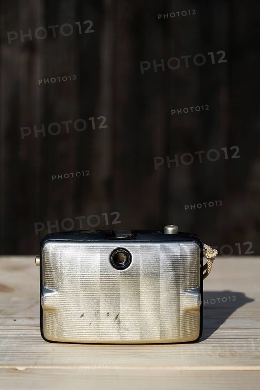 Back of old vintage golden Penti I camera, wooden background Prague Czech republic