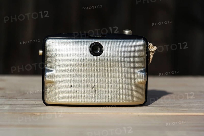 Back of old vintage golden Penti I camera, wooden background Prague Czech republic