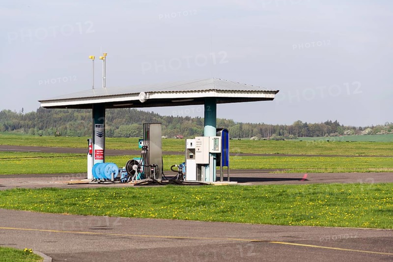Aviation fuel filling station on airport with airfield runway in background on a sunny spring day Prague Czech republic