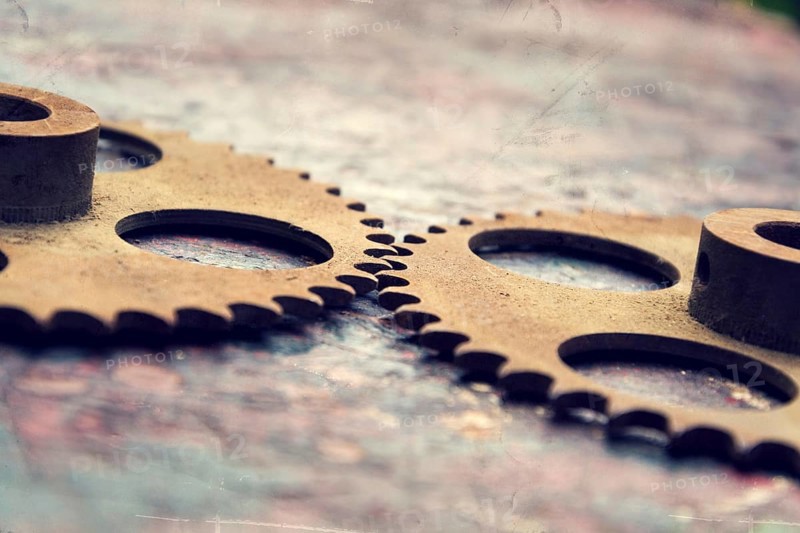 Filtered picture of cogwheels on a colorful wooden background Prague, Czech republic