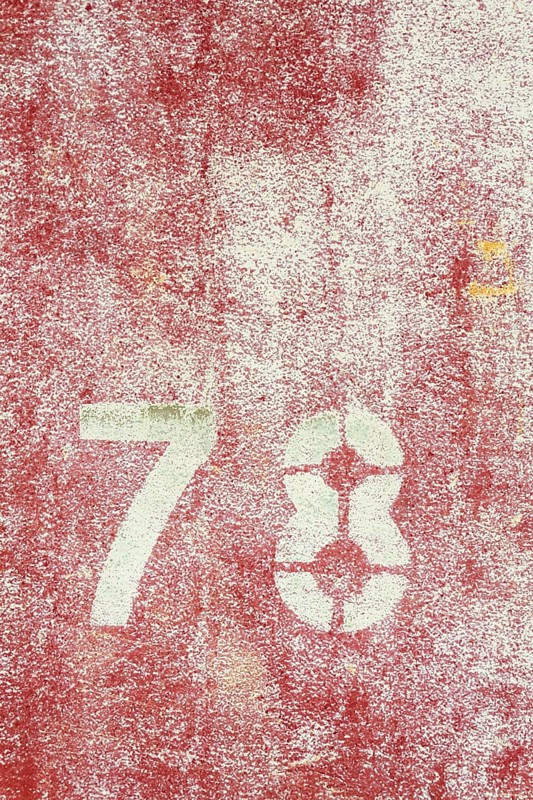 Number 78 on vintage rusty red and white metal sheet plate Prague, Czech republic