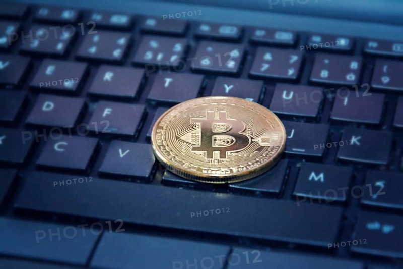 Golden bitcoin coin on computer keyboard, cryptocurrency bitcoin mining concept Prague Czech republic