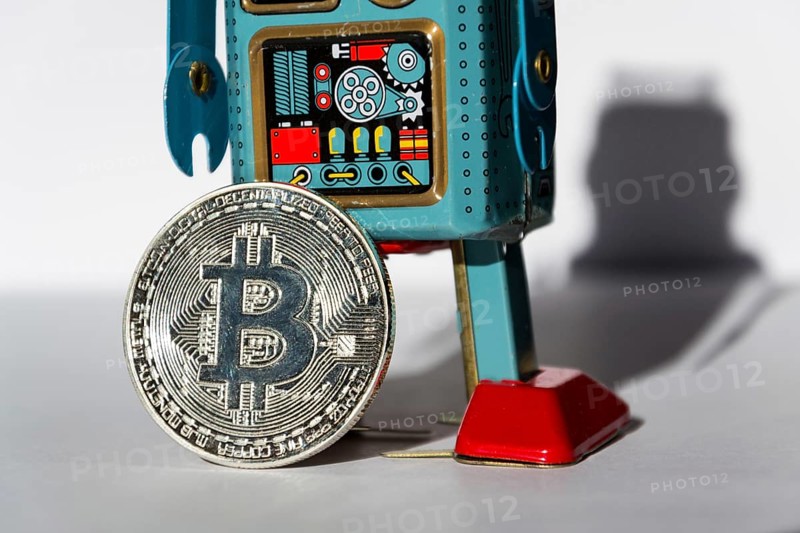 Vintage tin toy robot with bitcoin coin, cryptocurrency mining concept Prague Czech republic