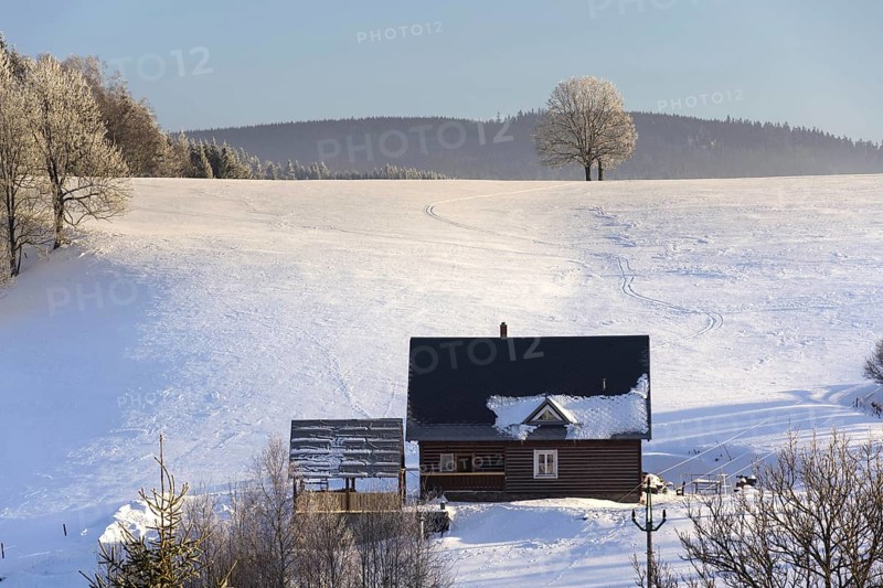Timbered cottage in frosty mountains country in sunny winter day Neratovice Czech republic