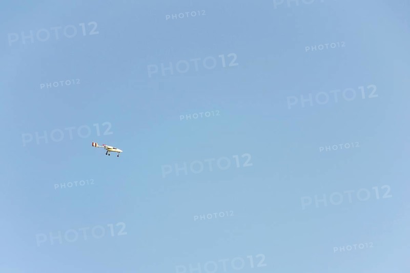 Unmanned aerial vehicle surveillance drone with light and camera flying, sunny summer day, drone delivery concept, copy space on clear sky Pisek Czech republic
