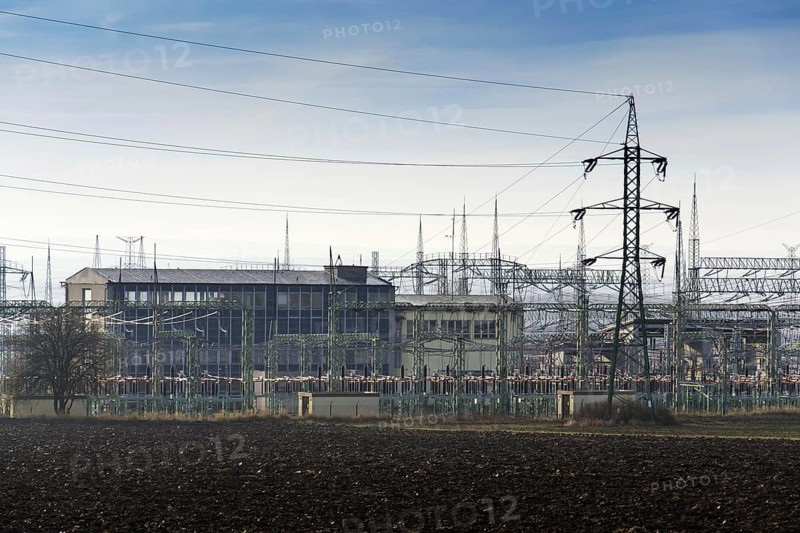 Distribution power station with electricity pylons and dramatic cloudy sky background Prague Czech republic