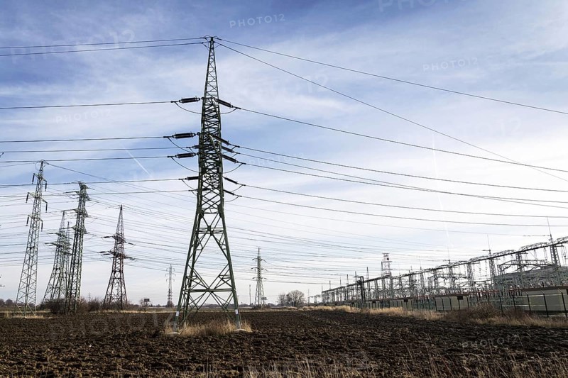 Electricity pylons with distribution power station blue cloudy sky background Prague Czech republic