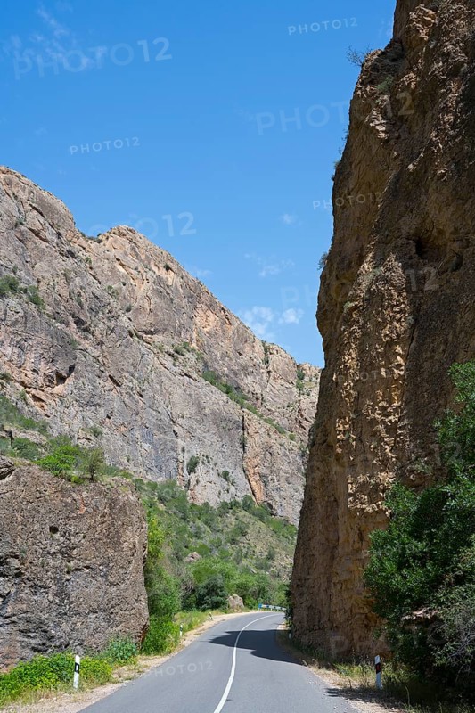 Asphalt road between high rock walls under clear sky, Amaghu Gorge from Noravank Monastery, Noravank, Vayots Dzor Province, Vayots Dzor, Armenia, Caucasus