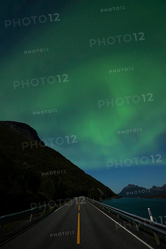 Tysfjord near Stetind Mountain in northern Norway under auroras and full moon