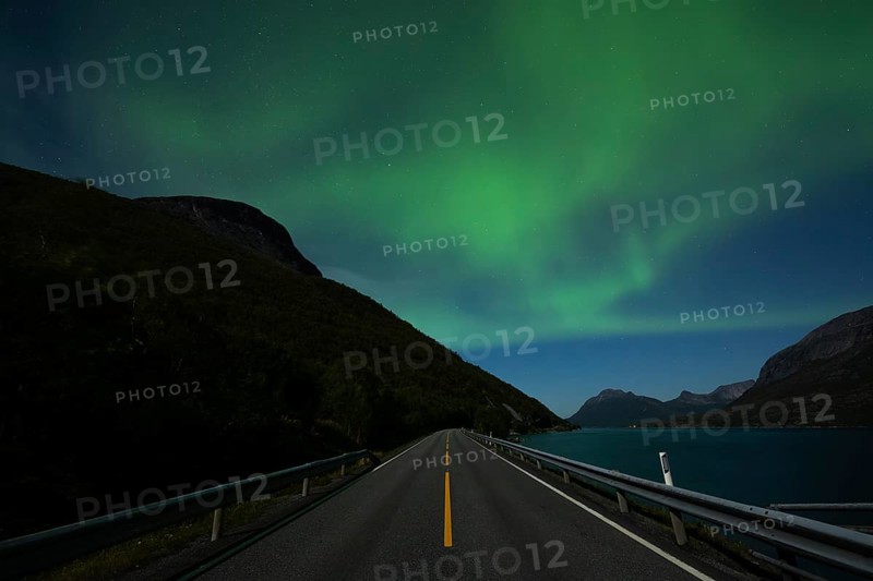 Tysfjord near Stetind Mountain in northern Norway under auroras and full moon