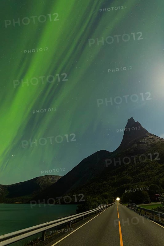 Magical Stetind, mountain in northern Norway under auroras and full moon
