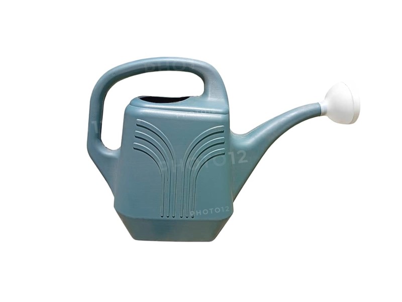 Close-up of a plastic garden watering can on a white background