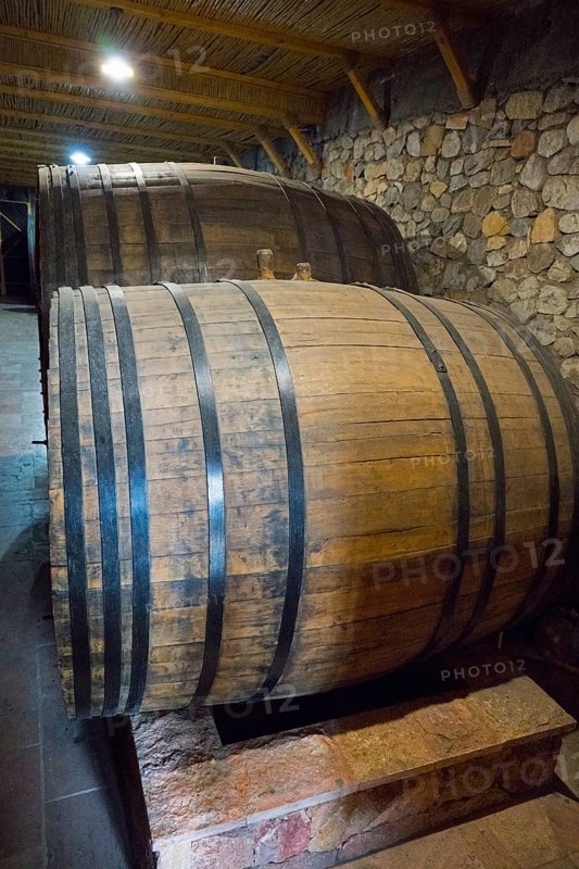 Two large wooden barrels in a cellar with rustic stone walls, Hin Areni Winery, Areni Village, Vayots Dzor Province, Wajoz Dzor, Armenia, Caucasus