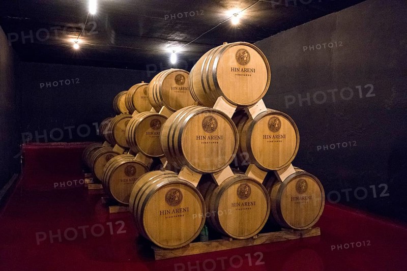 Many stacked wine barrels in a cellar with dim lights, Hin Areni Winery, Areni Village, Vayots Dzor Province, Wajoz Dzor, Armenia, Caucasus