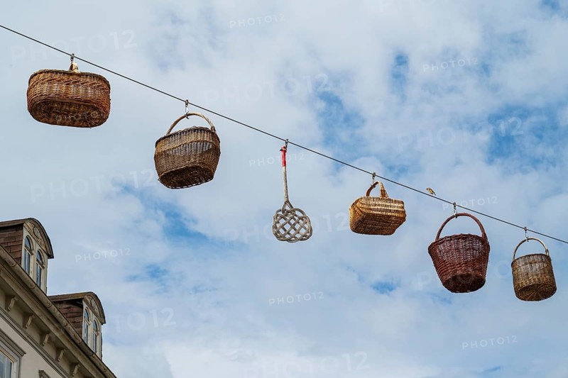 Woven baskets hang over the pedestrian zone in front of the sky, Deutsche Korbstadt, Lichtenfels, Upper Franconia, Bavaria, Germany