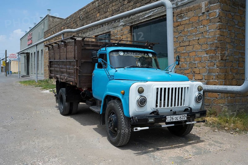 Old blue truck in front of a brick wall in an urban environment, GAZ-53 truck, Ararat, Ararat province, Armenia