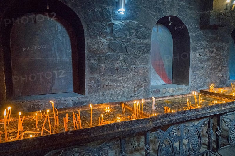 Candlelit room on the altar surrounded by dark stone walls and peaceful atmosphere, Khor Virap Monastery, Deep Dungeon, Ararat Province, Armenia