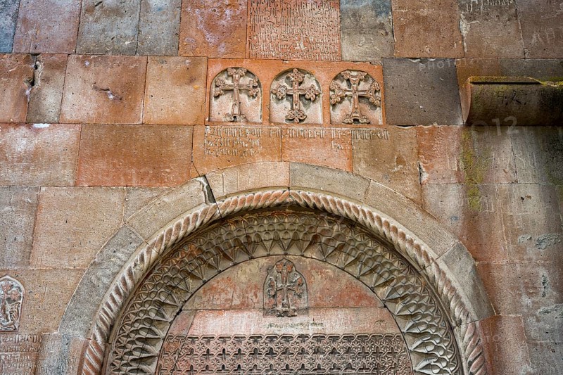 Detailed stone carving with crosses and carvings on an old church wall, Khor Wirap monastery, deep dungeon, Ararat province, Armenia