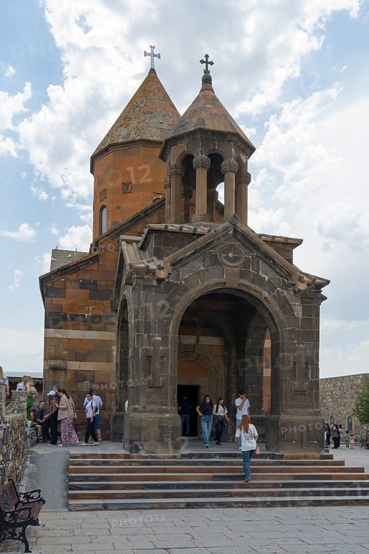 Church building with decorative entrance and dome, people enter the historic building, Khor Virap Monastery, Deep Dungeon, Ararat Province, Armenia
