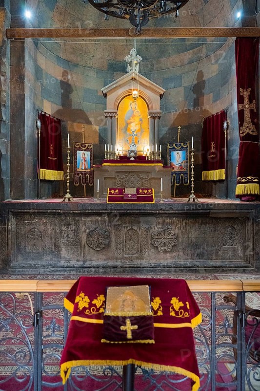 The altar with a variety of religious symbols and candles on decorated textiles, Khor Virap monastery, deep dungeon, Ararat province, Armenia