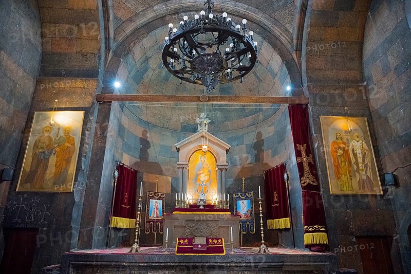 The church altar is decorated with icons and candles, framed by vaults and paintings, Khor Virap monastery, Chor Virap, deep dungeon, Ararat province, Armenia
