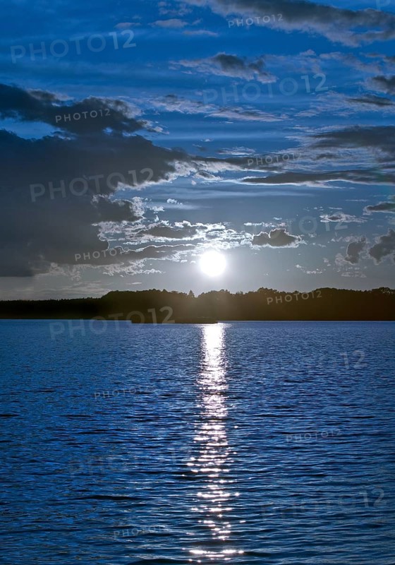 Atmospheric moonrise over Lake Gudelack, Lindow (Mark), Stechlin-Ruppiner Land nature park Park, Brandenburg, Germany