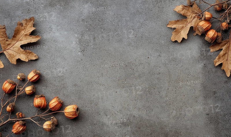 A grey background with a few leaves and some small orange fruits. The leaves are scattered around the background. AI generated