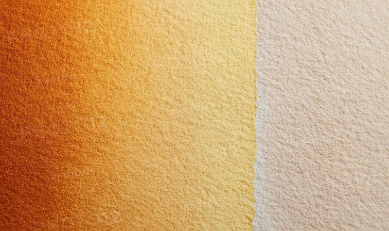 A tan and gold wall with a slightly darker shade of tan. The wall appears to be made of a textured material, giving it a unique. AI generated