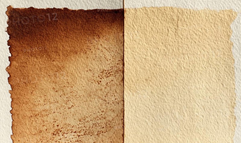 Two pieces of paper, one of which is brown and the other is white. The brown paper has a rough texture and he is aged, while the white paper is smooth. AI generated
