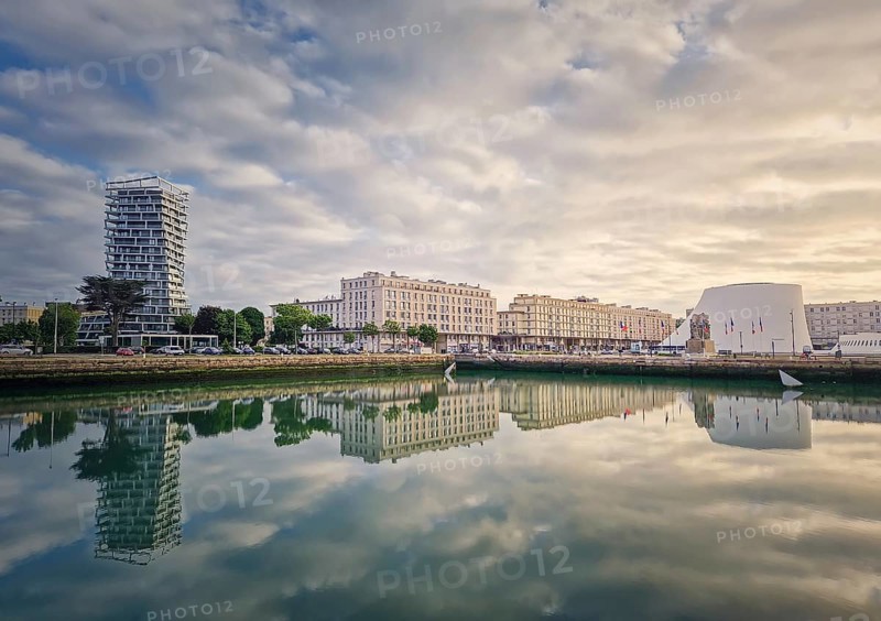 Beautiful waterfront scene in Le Havre, France at sunset. Buildings are perfectly reflected in the still water, Le Havre, Normandy, France