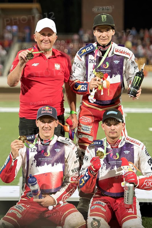 WROCLAW, POLAND - JULY 29, 2017: Speedway couple turnament during The World Games 2017. Decoration of gold medalist, from left team of Poland Marek Cieslak (manager), Patryk Dudek (20), Maciej Janowski (12) and Bartosz Zmarzlik (11)