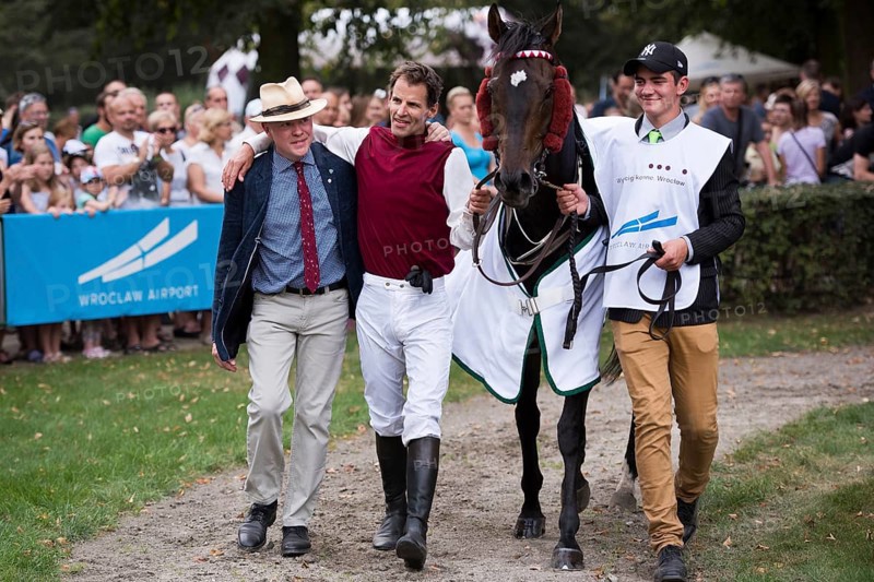 WROCLAW, POLAND - SEPTEMBER 4, 2016: Horse racing - Grand Partynicka at Racecourse WTWK Partynice. Winner N. Loven (C) and his horse Calvados after decoration