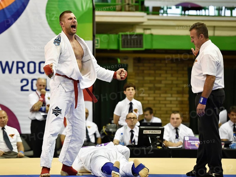 WROCLAW, POLAND - JULY 29, 2017: Ju-Jitsu Fighting tournament during the The World Games 2017. Semifinal fight between Tomasz Szewczak POL (red) - Benjamin Lah SLO (blue). Tomasz Szewczak joy after the fight