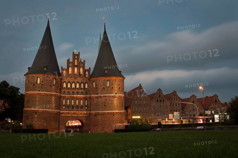 LUBECK, GERMANY - AUGUST 3, 2016: Holstentor Gate during twilight. Lubeck old town is on a UNESCO World Heritage Site