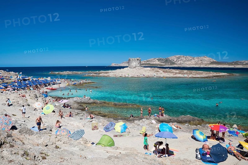 STINTINO, ITALY - AUGUST 21, 2017 - Unidentified people in the sun on the famous La Pelosa Beach on island Sardinia