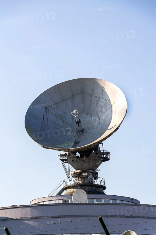 Radar antenna on satellite links center, telecommunication tower, wireless communication concept, clear blue sky on a sunny day Prague, Czech republic