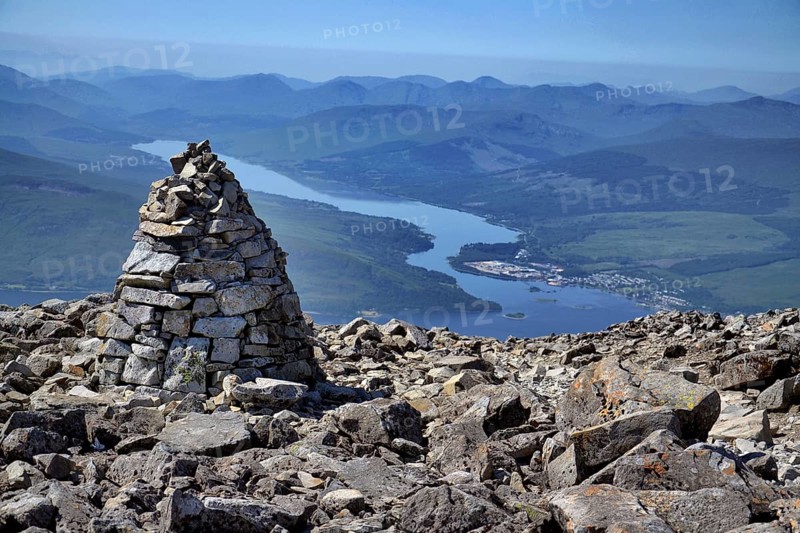 Stone mound tumulus on the Ben Nevis summit, the highest mountain in the United Kingdom, Loch Eil in background, Highlands, Scotland