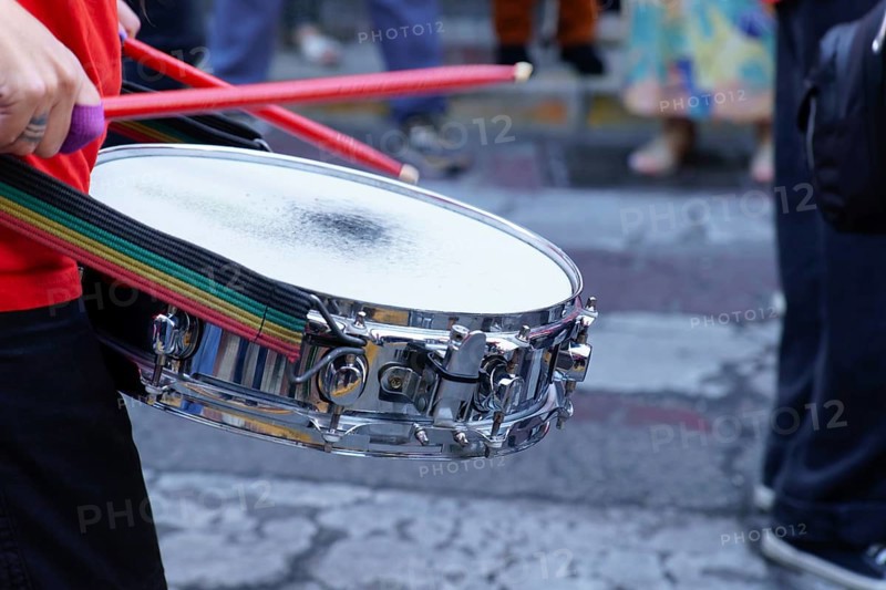 Ronda, malaga, spain Drummer playing snare drum with red drumsticks during a vibrant street parade, creating rhythm and music