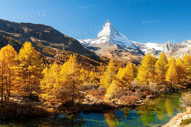 Matterhorn Mountain, Grindjisee Lake and Yellow Larches in Autumn on Sunny Day. Swiss Alps. Valais, Switzerland