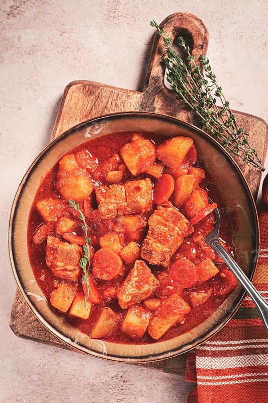 Meat goulash with potatoes and carrots, sweet peppers, in a saucepan, top view, traditional Hungarian soup, homemade, no people