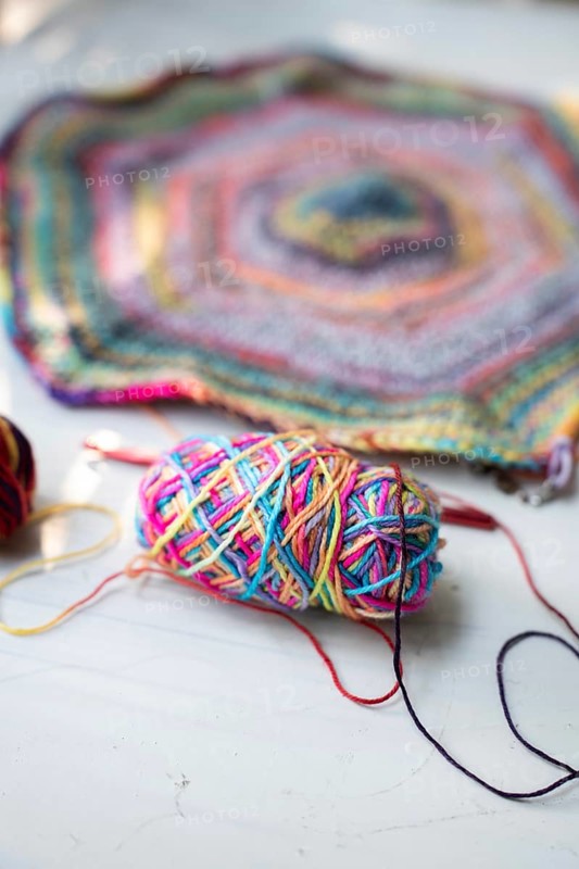 Crochet hooks, wool and crocheted blanket