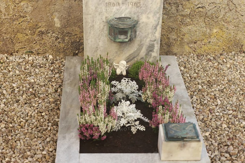 Children's grave with angel figure and beautiful flower decoration for All Saints on a cemetery wall, Upper Bavaria, Bavaria, Germany