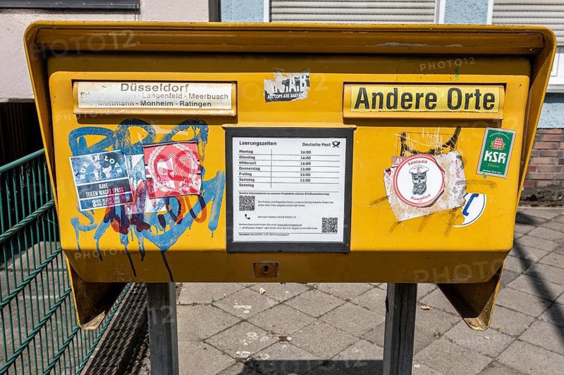 Painted and stickered post box in Mörsenbroich — Düsseldorf, North Rhine-Westphalia, Germany