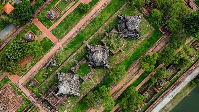 An ancient temple complex next to a city and a modern temple, in Thailand, seen from above